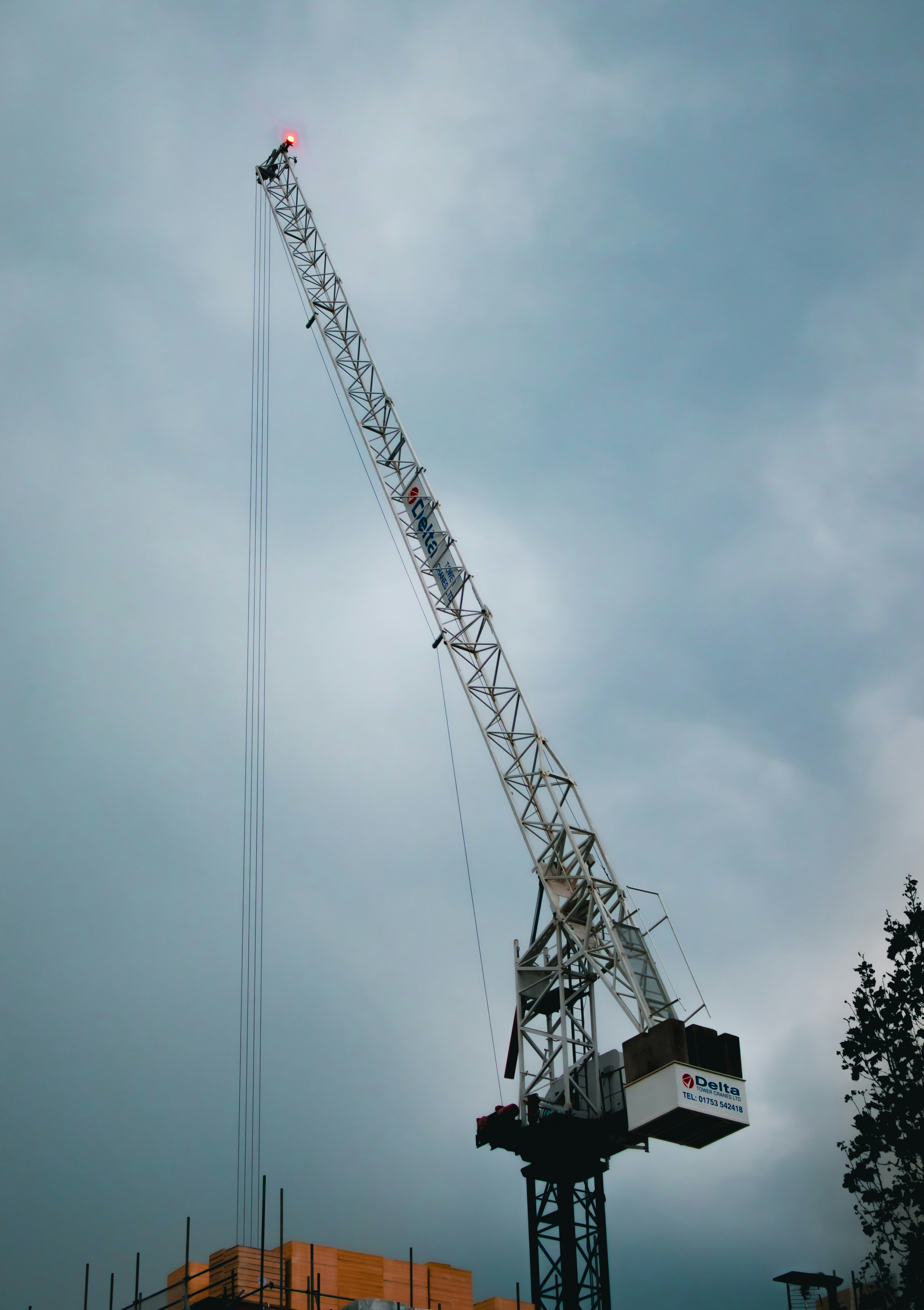 gray steel crane under cloudy sky during daytime